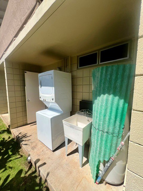 A bathroom with a toilet, sink, and shower curtain.